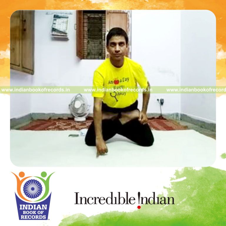 individual performing knee stand with fingertip support while holding lotus pose for record in Indian Book of Records