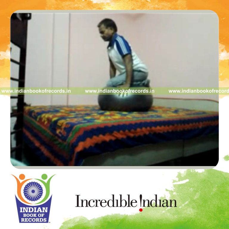 individual kneeling on exercise ball for record in Indian Book of Records