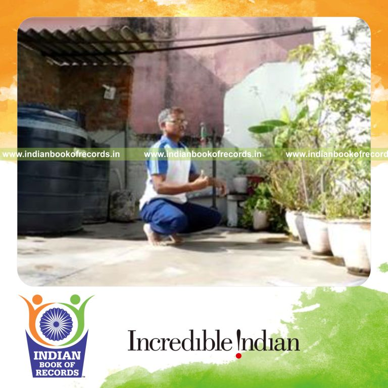 individual balancing kitchen knife on thumb while sitting on toes for record in Indian Book of Records