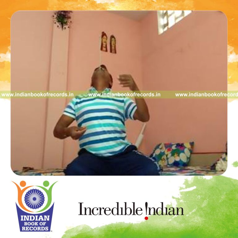 individual balancing knitting needle on chin for record in Indian Book of Records