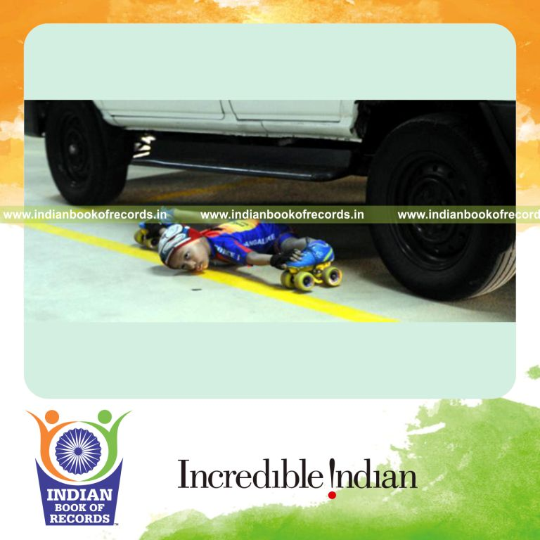 young boy performing limbo skating under cars for Indian Book of Records