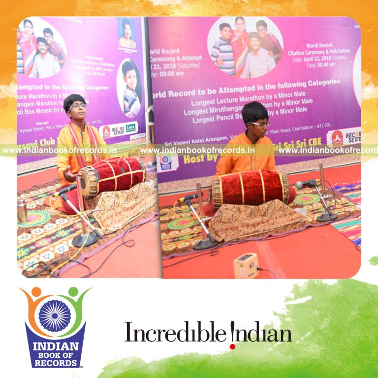 minor male performing mridangam marathon for Indian Book of Records