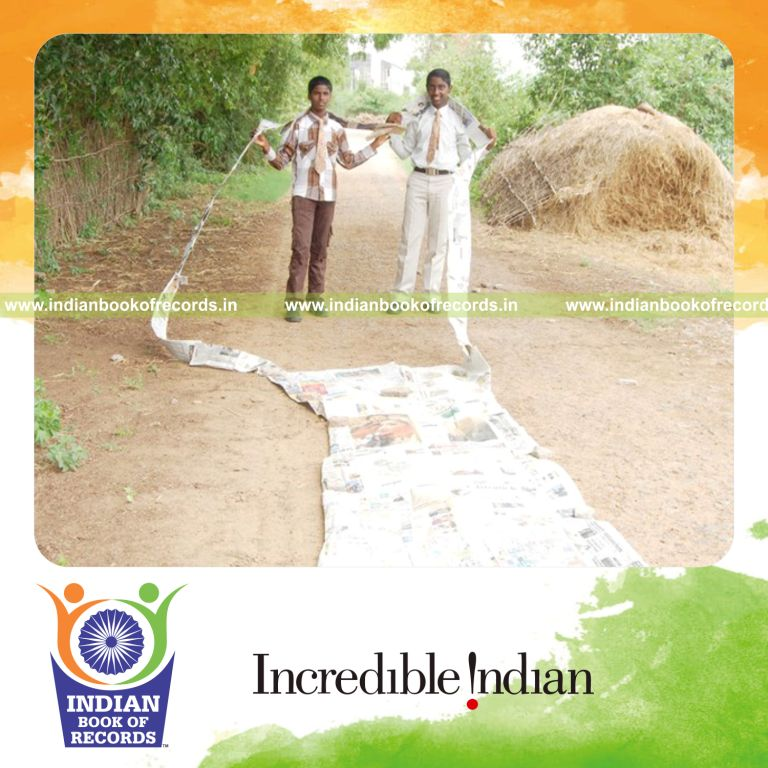 team creating long tie using paper for record in Indian Book of Records