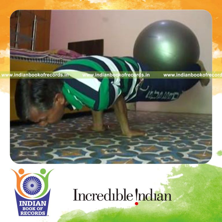 individual holding peacock pose while holding exercise ball between legs for record in Indian Book of Records