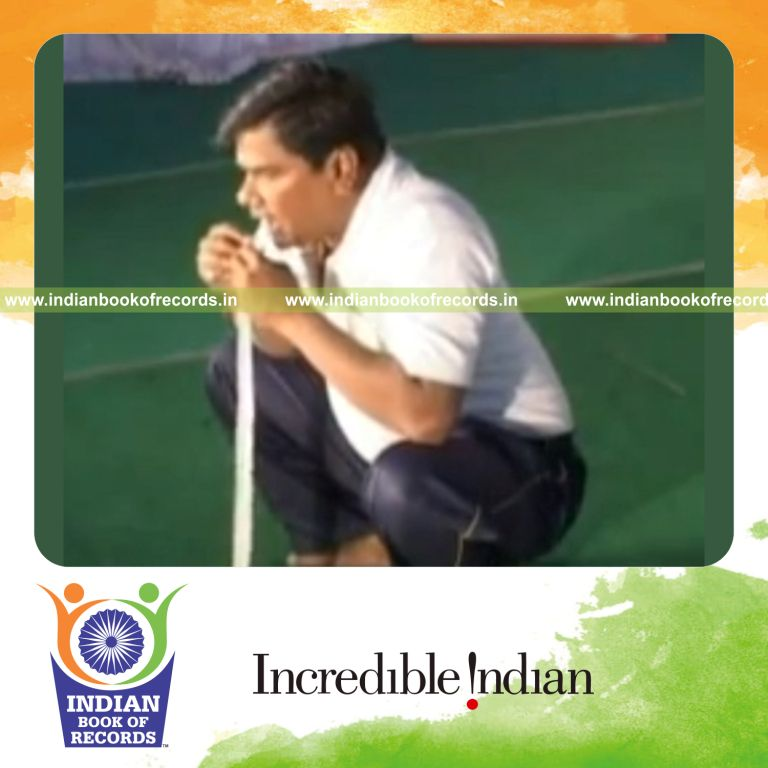 male individual performing act of swallowing long piece of cloth for record in Indian Book of Records