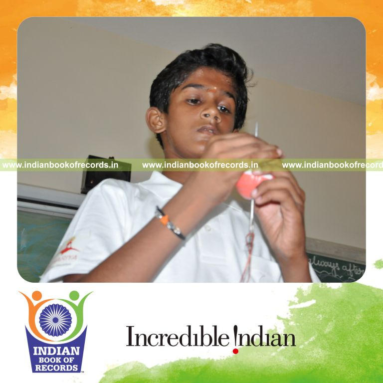 young male creating plastic ball chain within one hour for record in Indian Book of Records