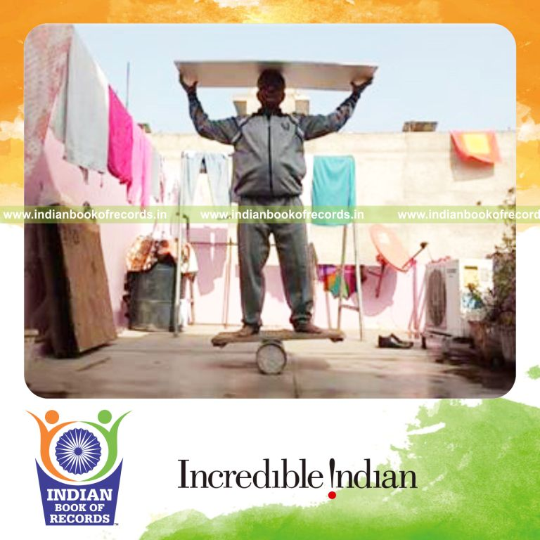 individual balancing pvc board on head while standing on balance board for record in Indian Book of Records