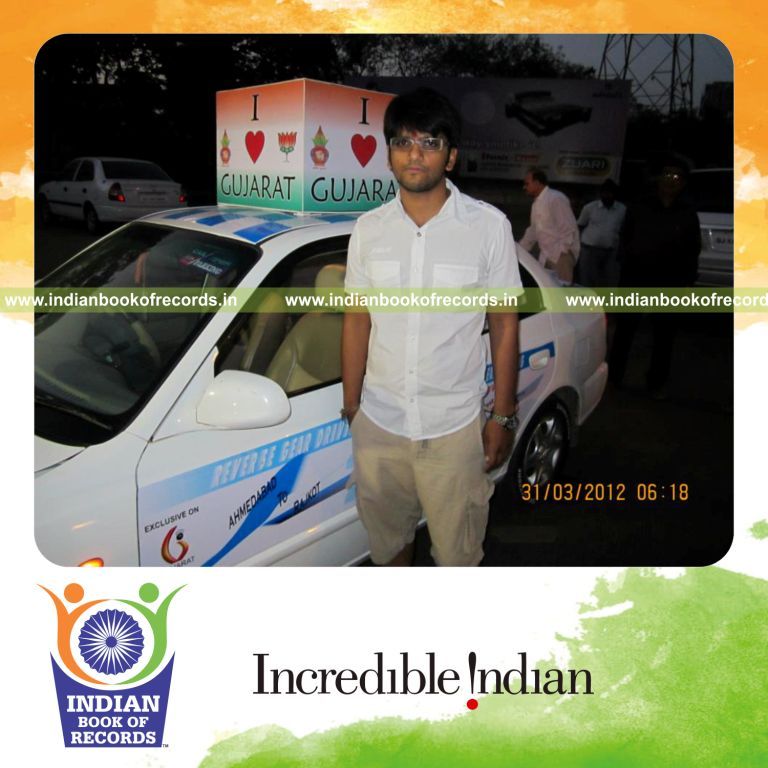 male individual driving car in reverse continuously for record in Indian Book of Records