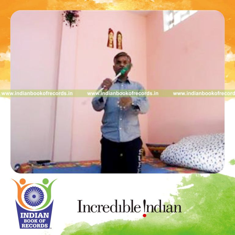 individual balancing screwdriver on chin while kneeling for record in Indian Book of Records