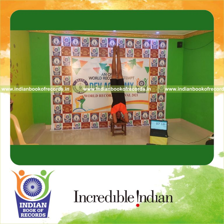 A challenging headstand performed on a stool held steadily for a long duration recognized by Indian Book of Records