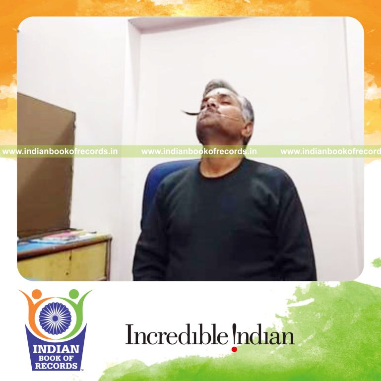 individual balancing spoon on toothpick held in mouth for longest duration for record in Indian Book of Records