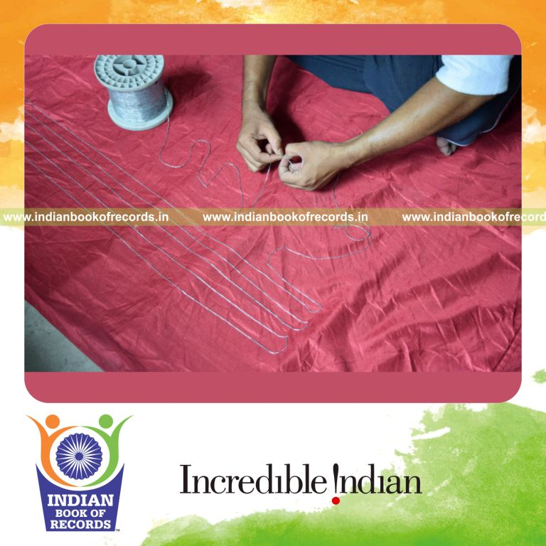 an individual connecting multiple metal staples together to form a continuous long chain for a record in Indian Book of Records