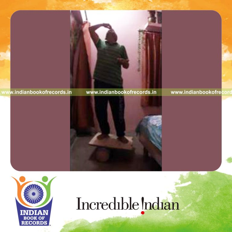 individual balancing starburst tower on forehead while standing on rola bola for record in Indian Book of Records