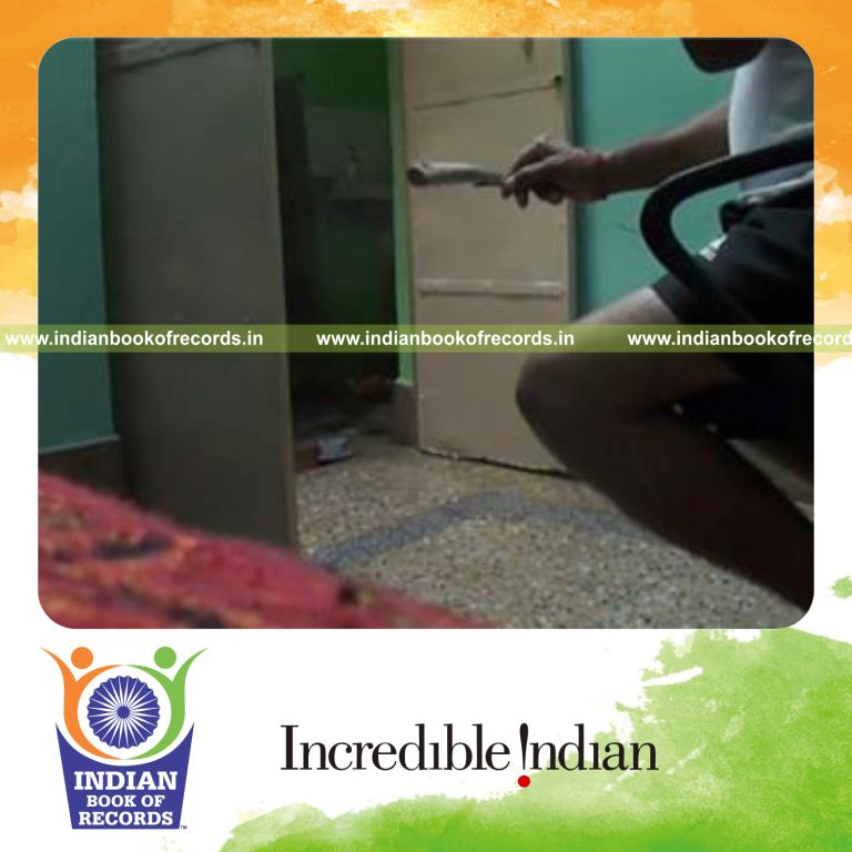 individual balancing circular wooden stick on iron nail held in hand for record in Indian Book of Records