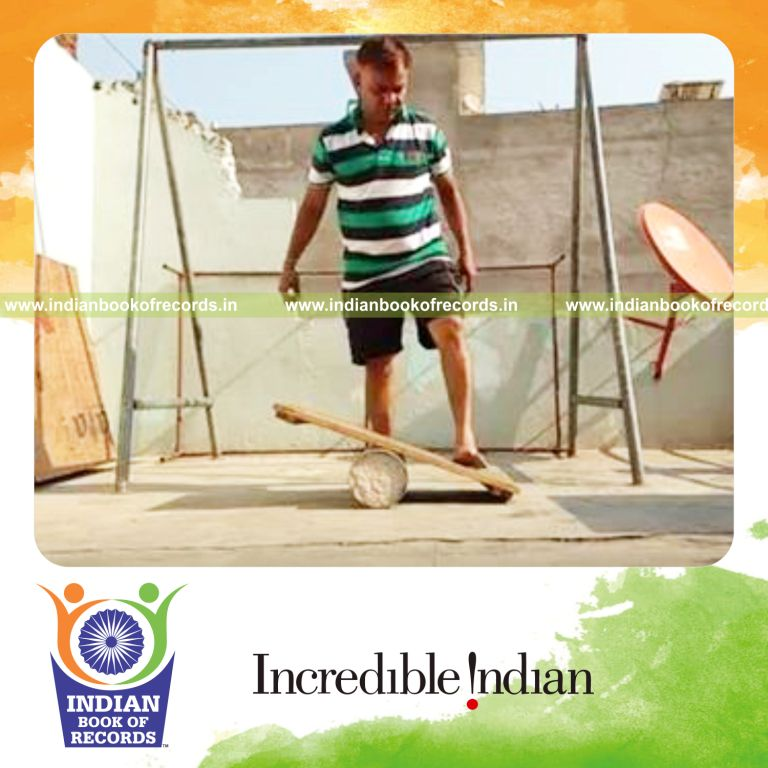 individual holding sumo pose while balancing on rola bola for record in Indian Book of Records