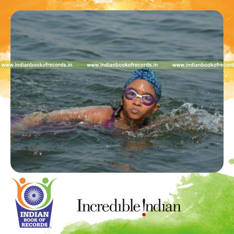young girl swimming long distance in natural water body for Indian Book of Records