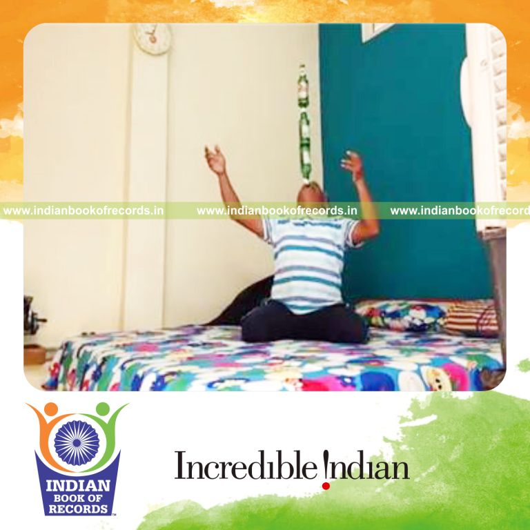 individual balancing three beer bottles on chin while kneeling for longest duration for record in Indian Book of Records
