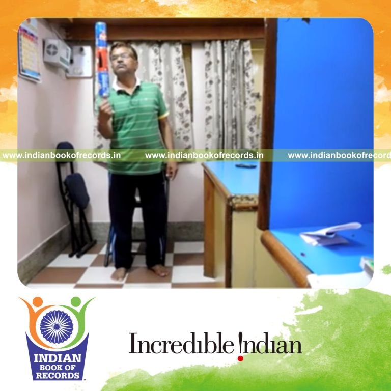 individual balancing three soda cans on thumb for record in Indian Book of Records