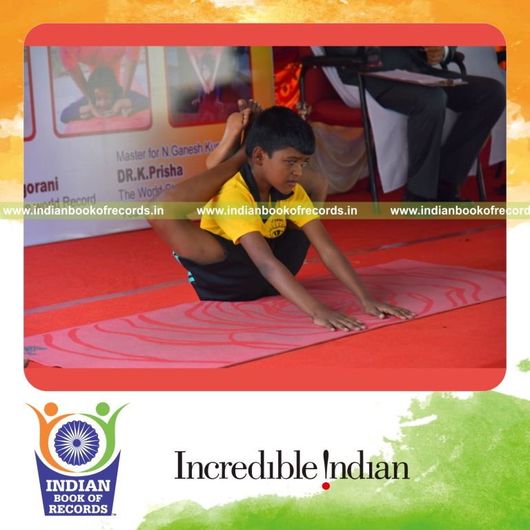 individual minor male holding thuvi pada sirsasana yoga pose for record in Indian Book of Records