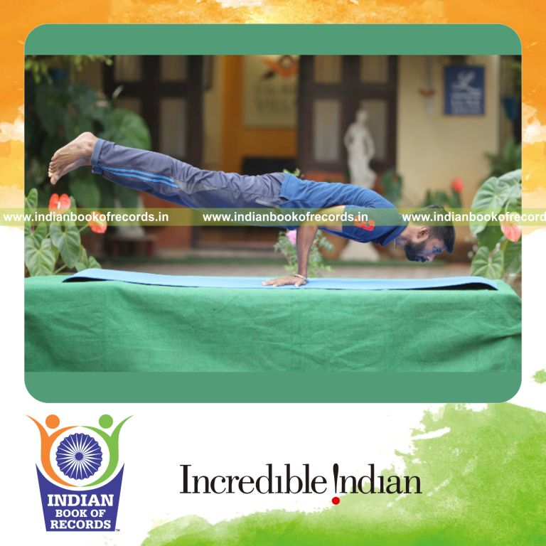 an individual maintaining the peacock yoga pose for the longest duration with balance and control for a record in Indian Book of Records