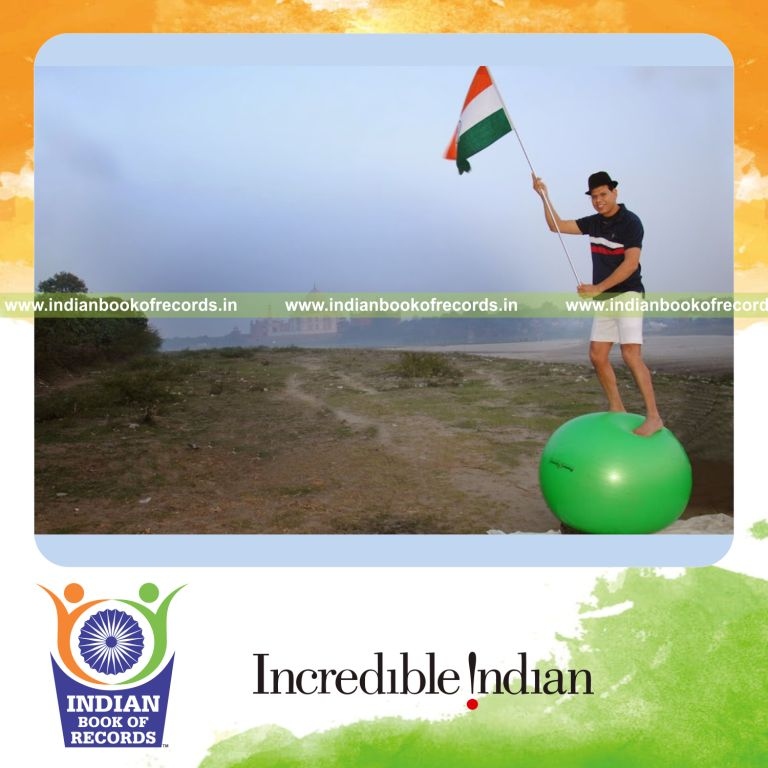 male individual balancing on swiss ball for extended time for record in Indian Book of Records