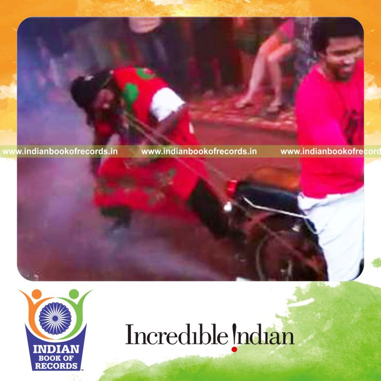 individual stopping a running motorcycle using teeth for longest time for record in Indian Book of Records