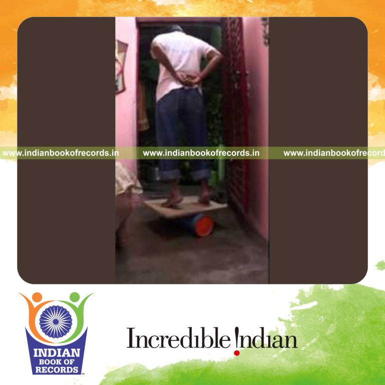 individual balancing on toes on balance board for record in Indian Book of Records