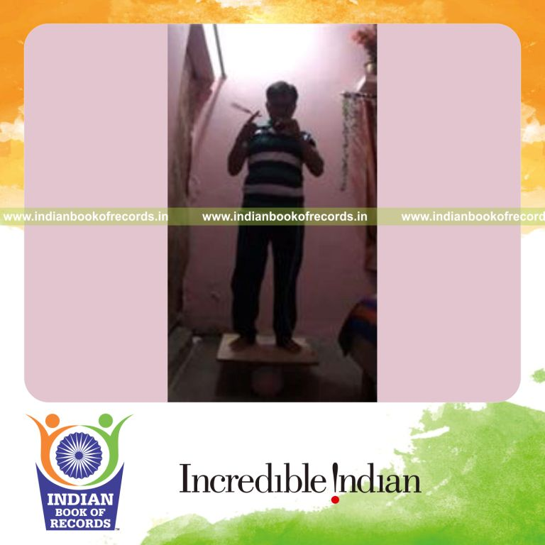 individual spinning toothbrush on finger while brushing teeth and balancing on rola bola for record in Indian Book of Records