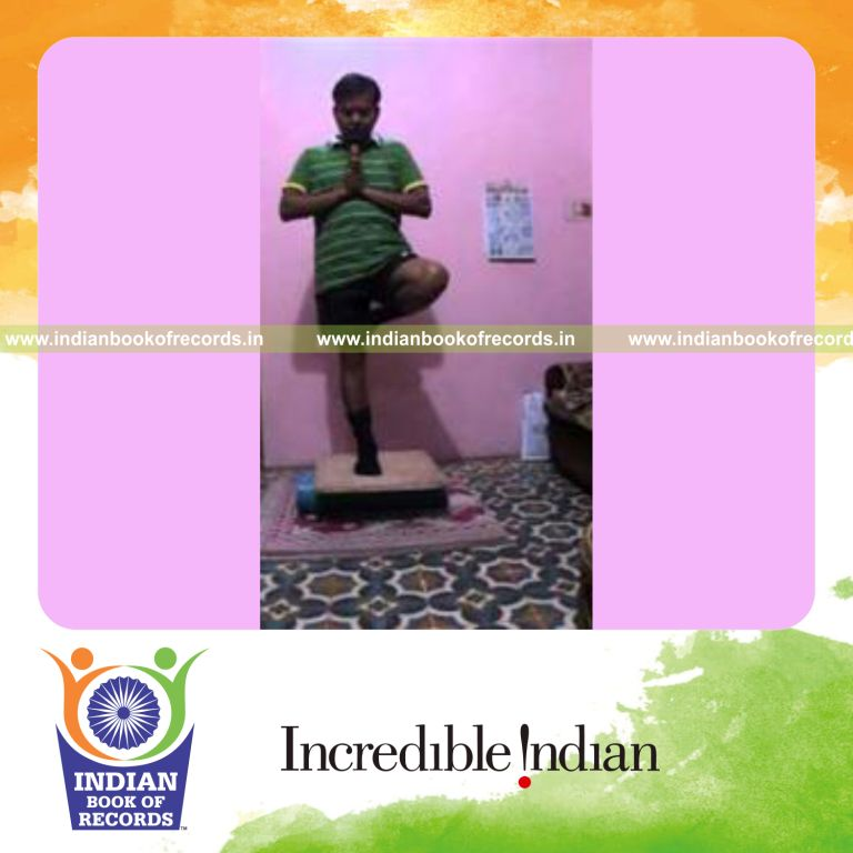individual holding yoga tree pose on balance board for record in Indian Book of Records