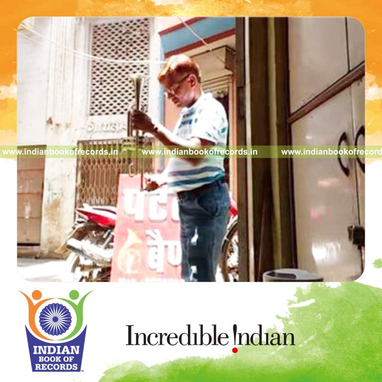 individual balancing trumpet on finger for longest time for record in Indian Book of Records