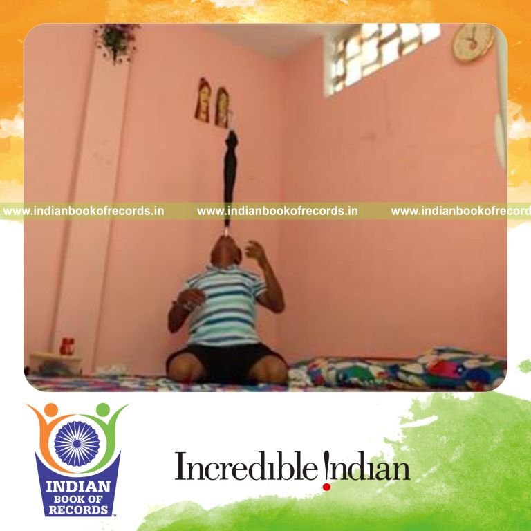 individual balancing umbrella on forehead while kneeling for longest time for record in Indian Book of Records