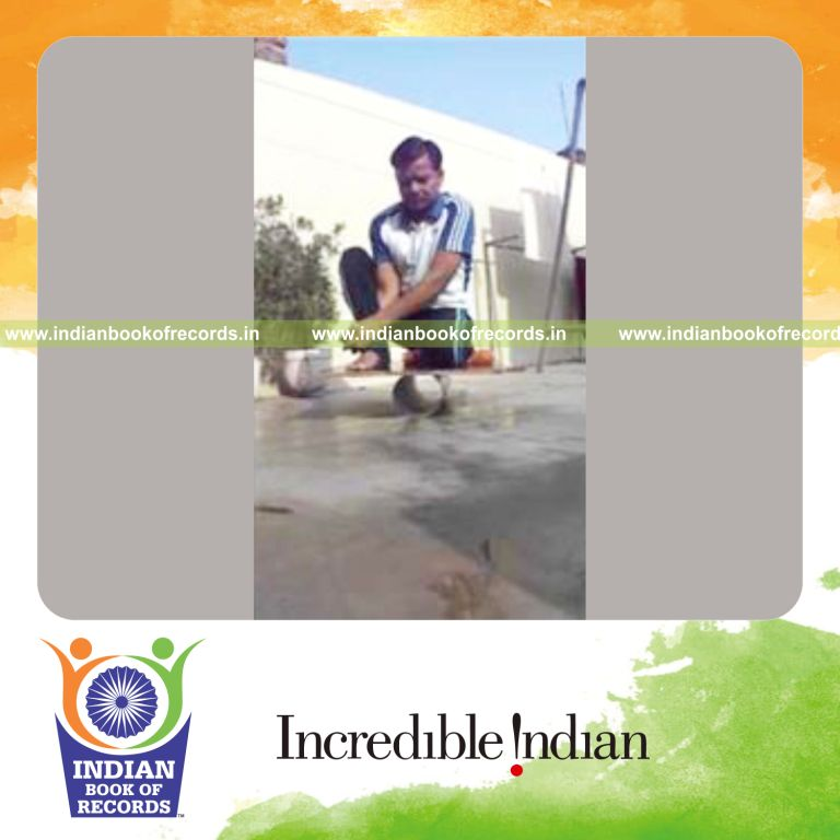 individual holding vajra veerasana pose on balance board with clamped hands for record in Indian Book of Records
