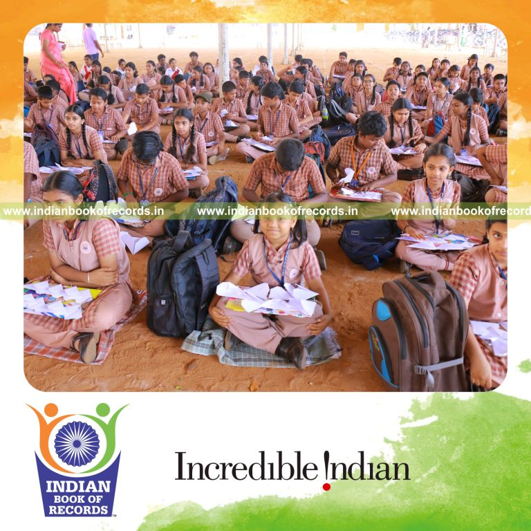 Large number of participants creating origami hearts together at a single venue for Indian Book of Records