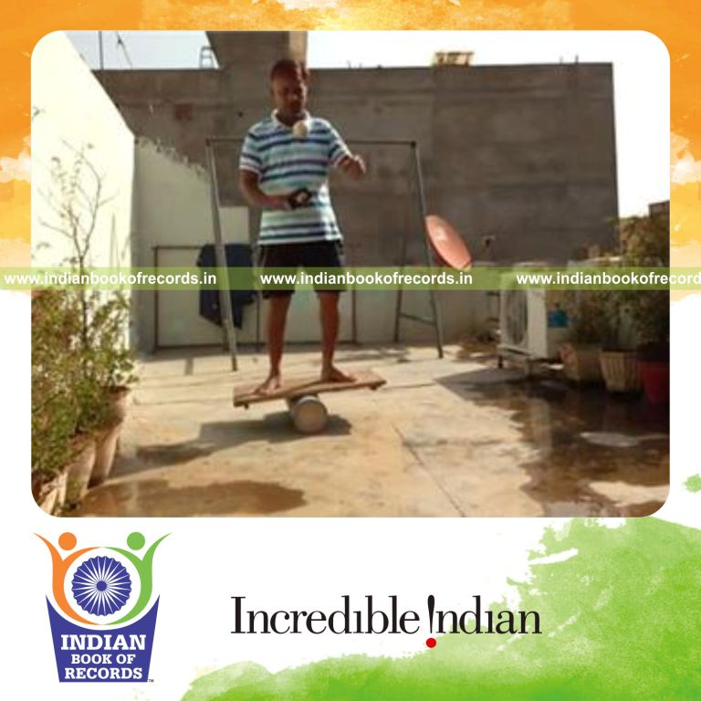 individual bouncing baseball on rubber mallet while balancing on rola bola for record in an Indian Book of Records
