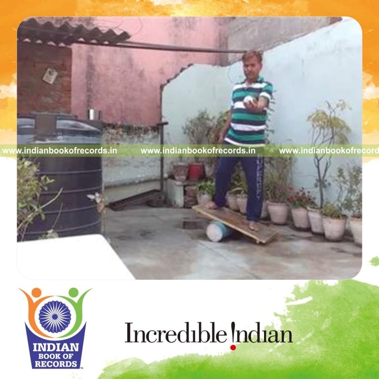 individual bouncing baseball on rubber mallet while balancing on rola bola for record in Indian Book of Records