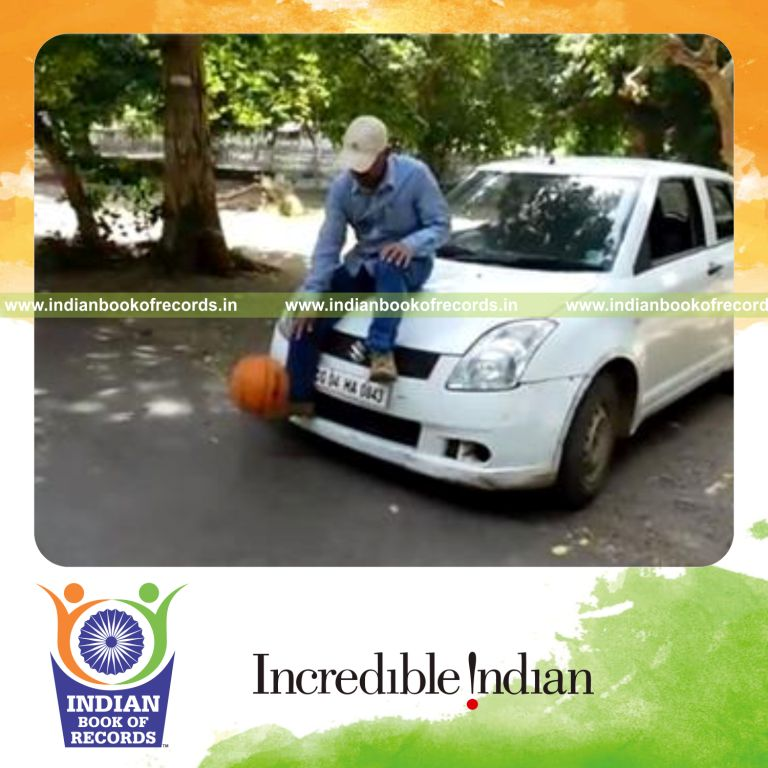 individual dribbling basketball while sitting on four wheeled vehicle in one minute for record in Indian Book of Records