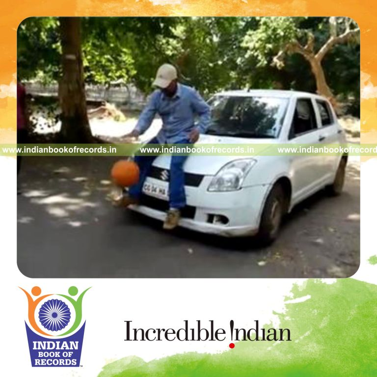 individual dribbling basketball while sitting on four wheeled vehicle in 30 seconds for record in Indian Book of Records
