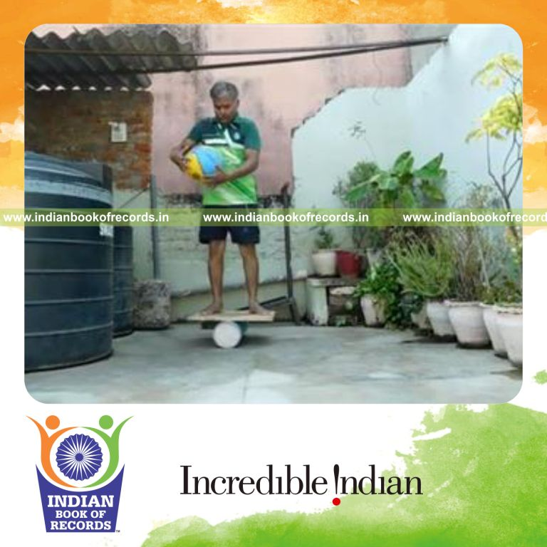 individual circling basketball around waist in one minute while balancing on rola bola for record in Indian Book of Records