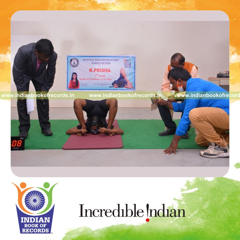 individual female performing thumb and pinky brain gym exercise while holding kanda perundasana blindfolded for Indian Book of Records