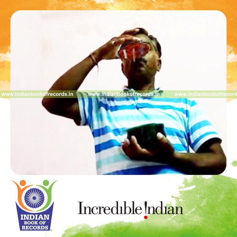 individual stacking cds on pencil held in mouth for record in Indian Book of Records