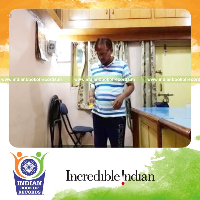 individual bouncing golf ball on wooden ruler using one hand for record in Indian Book of Records