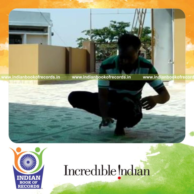 individual dribbling golf ball repeatedly while sitting on left foot toes for record in Indian Book of Records