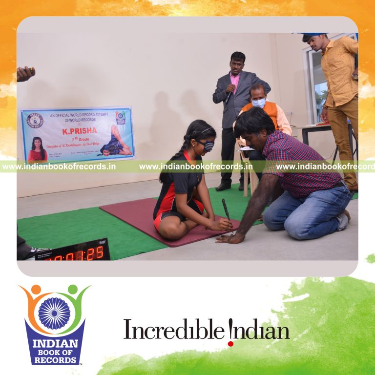 individual female performing knife stabs between another persons fingers while holding vamadevasana blindfolded for Indian Book of Records