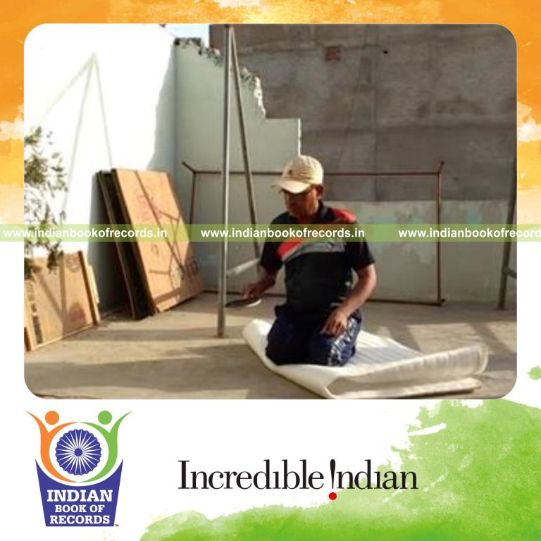 individual bouncing marbles on paddle while kneeling for record in Indian Book of Records