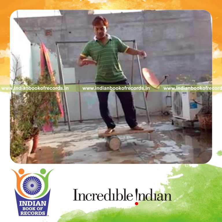 individual bouncing marbles on paddle while balancing on rola bola for record in Indian Book of Records
