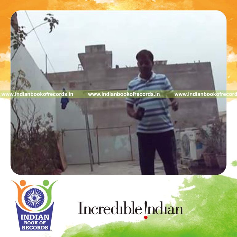 individual bouncing marble alternately on rubber mallet for record in Indian Book of Records