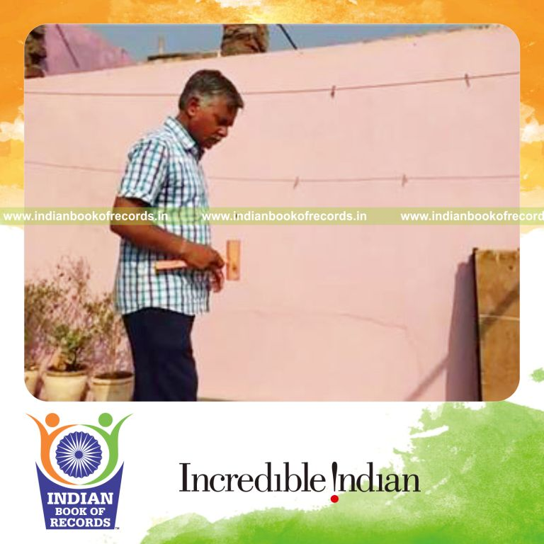 individual bouncing marble on wooden mallet for record in Indian Book of Records