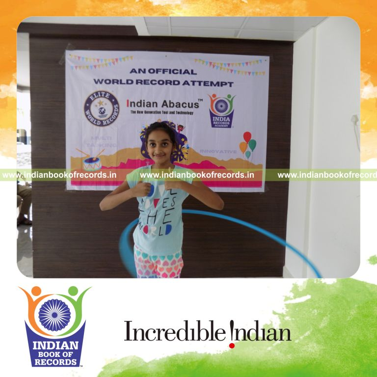 individual female solving mental arithmetic problems while performing hula hoop for Indian Book of Records