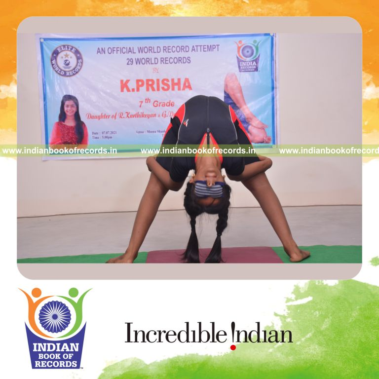 individual female performing niralamba poorna chakrasana yoga pose blindfolded for Indian Book of Records