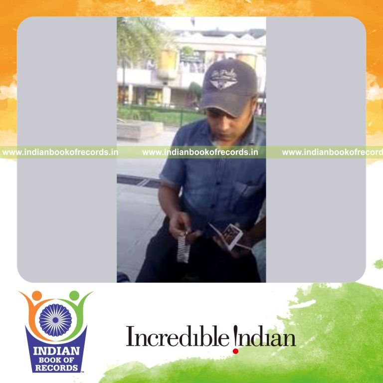 individual performing one handed triple card cuts in one minute for record in Indian Book of Records